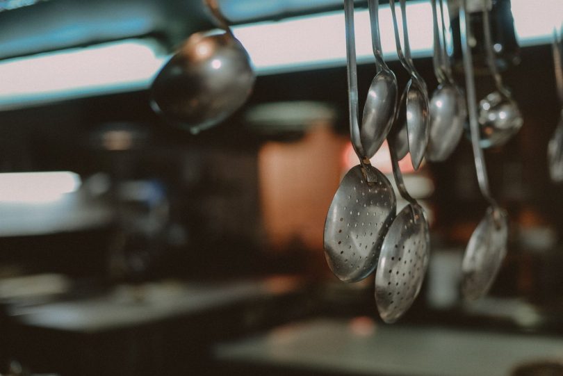 Técnico realizando inspeção de controle de pragas em cozinha de restaurante